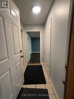Bradford West Gwillimbury (Bradford) apartment for rent - A hallway with a black and white rug on the floor.