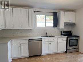 Bradford West Gwillimbury (Bradford) apartment for rent - A kitchen with white cabinets and a stainless steel dishwasher.