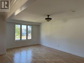 Bradford West Gwillimbury (Bradford) apartment for rent - A room with a ceiling fan and a window overlooking a street.