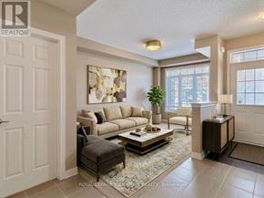 Oakville (Go Glenorchy) townhouse for rent - A living room with a couch, chair, and a rug.