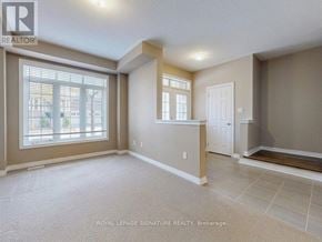 Oakville (Go Glenorchy) townhouse for rent - A spacious room with a large window and a door is on the market with Royal LePage Signature Realty in Brokerage.