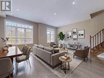 Oakville (Go Glenorchy) townhouse for rent - A well-lit living room with a grey sofa and a wooden coffee table.