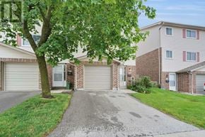London South (South T) townhouse for rent - A tree is in front of a house with a driveway.