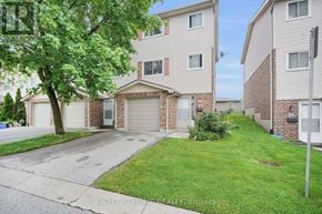 London South (South T) townhouse for rent - A residential area with a house and a tree in front.