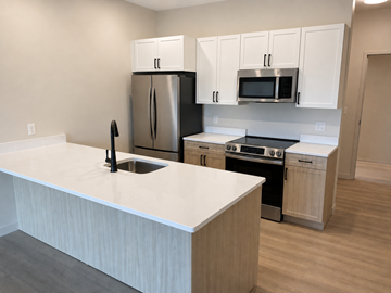 East Providence apartment for rent - A kitchen with a white counter top and stainless steel appliances.