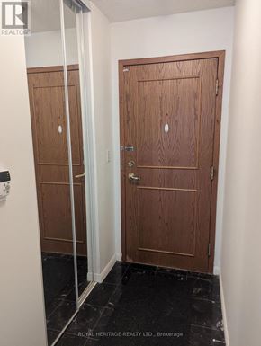Toronto (Woburn) condo for rent - A hallway with two doors and a glass partition.