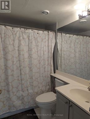 Toronto (Woburn) condo for rent - A white toilet sits next to a sink in a bathroom.