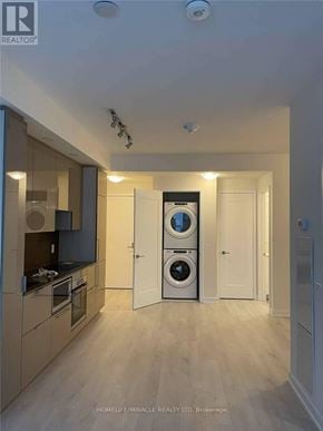 Toronto (Waterfront Communities) condo for rent - A modern kitchen with a washing machine built into the cabinetry.