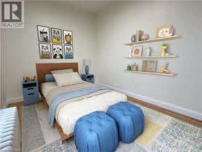 Brantford apartment for rent - A bedroom with a bed, two blue ottomans, and shelves with decorative items.