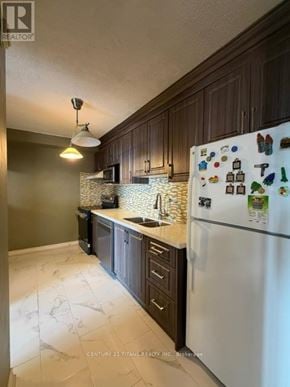 Toronto (Eglinton East) condo for rent - A kitchen with a white fridge and a marble floor.