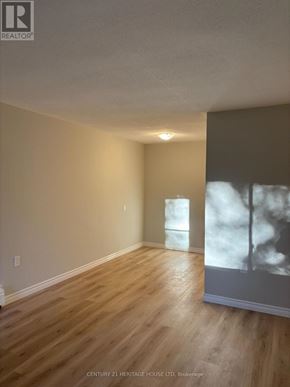St. Thomas multi-family for rent - A room with wooden floors and a wall with a picture of a tree.