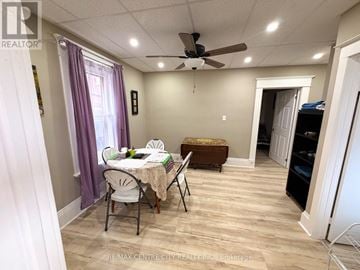Brantford multi-family for rent - A dining room with a table set for two and a ceiling fan.