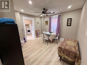 Brantford multi-family for rent - A bedroom with a bed, chair, and a dining table.