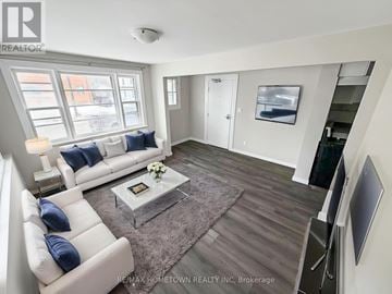 Brockville multi-family for rent - A living room with a white couch and a coffee table.
