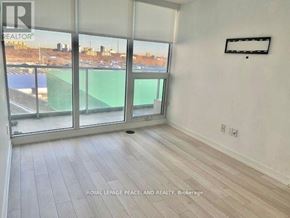 Toronto (Bayview Village) condo for rent - A room with a large window overlooking a tennis court.