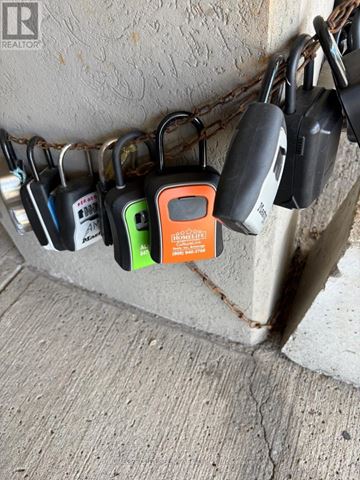 Toronto (Woburn) condo for rent - A row of padlocks are attached to a chain and a post.