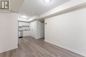 Toronto (Eglinton East) townhouse for rent - A real estate listing photo of a kitchen and living room.