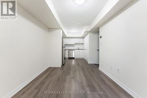 Toronto (Eglinton East) townhouse for rent - A long hallway with a kitchen area at the end.