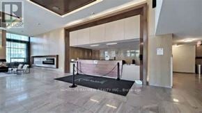 Markham (Unionville) condo for rent - A spacious living room with a black carpet and a large window.