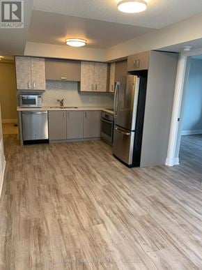 Markham (Unionville) condo for rent - A kitchen with wooden flooring and stainless steel appliances.
