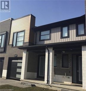 London North (North M) townhouse for rent - A modern house with a garage and a number 977 on the front.