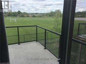 London North (North M) townhouse for rent - A balcony with a view of a field and a tower in the distance.