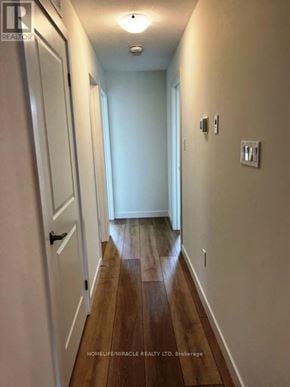 Cambridge townhouse for rent - A long hallway with wood floors and white walls.