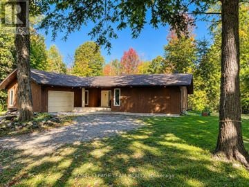 North Grenville apartment for rent - A house with a brown roof and a gravel driveway in front of it.