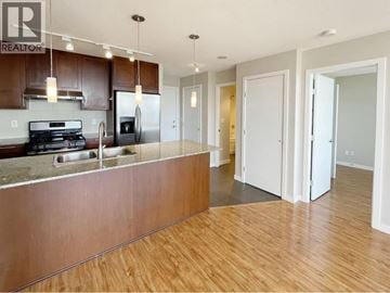 Burnaby apartment for rent - A kitchen with a stove top oven and a refrigerator.