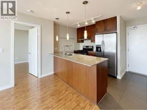 Burnaby apartment for rent - A kitchen with a wooden island and stainless steel appliances.