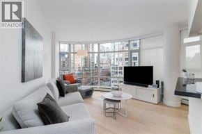 Vancouver apartment for rent - A living room with a grey couch and a television.