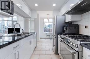 Vancouver apartment for rent - A modern kitchen with a black refrigerator and stove.