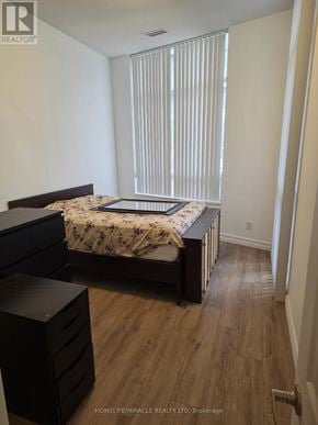 Toronto (Willowdale East) condo for rent - A bedroom with a bed, nightstand, and dresser.