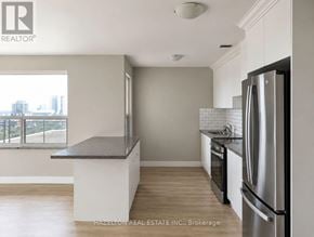 Toronto (Annex) condo for rent - A kitchen with a refrigerator, oven, and microwave.
