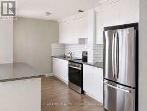 Toronto (Annex) condo for rent - A kitchen with a refrigerator, oven, and sink.