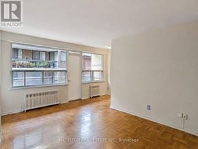 Toronto (Annex) condo for rent - A room with a large window and a balcony is for sale.