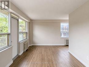 Toronto (Annex) condo for rent - A room with wooden floors and white walls, with a window on the left side.