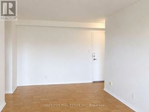 Toronto (Annex) condo for rent - A room with a door and a wooden floor.