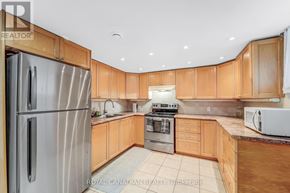 Toronto (West Hill) apartment for rent - A kitchen with wooden cabinets and a stainless steel refrigerator.