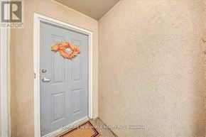 Toronto (Clairlea-Birchmount) townhouse for rent - A door with a wreath on it is in a room with beige walls.