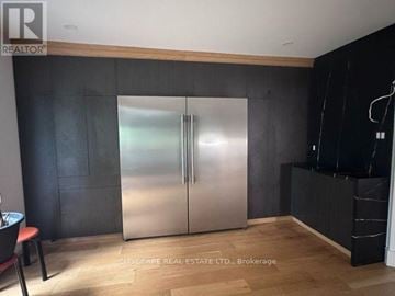 Toronto (Kingsview Village-The Westway) townhouse for rent - A modern kitchen with a stainless steel refrigerator and wooden accents.