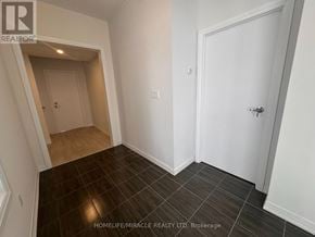 Brampton (Bram East) duplex for rent - A room with a white door and a brown floor.