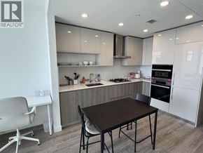 Burnaby apartment for rent - A modern kitchen with a dining table and chairs.