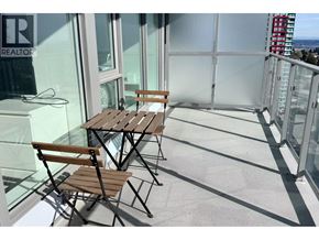Burnaby apartment for rent - A table and two chairs are on a balcony.
