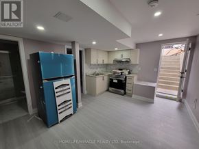 Brampton (Credit Valley) apartment for rent - A blue and white refrigerator stands in a kitchen with white cabinets and a marble countertop.