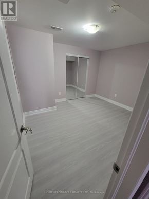 Brampton (Credit Valley) apartment for rent - A room with a door and a mirror on the wall.