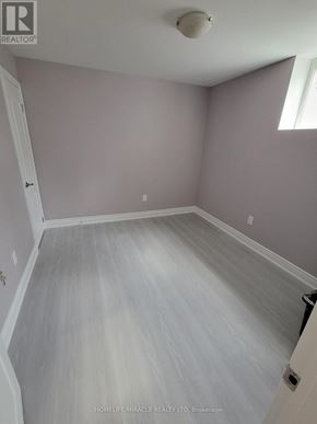 Brampton (Credit Valley) apartment for rent - A room with a grey floor and a white door.