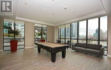 Mississauga (City Centre) condo for rent - A living room with a pool table and a couch.