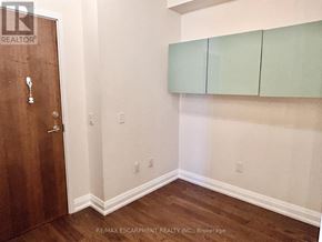 Mississauga (City Centre) condo for rent - A room with a brown door and green cabinets.