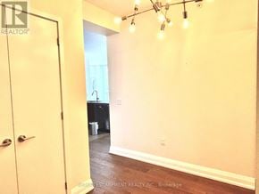 Mississauga (City Centre) condo for rent - A room with a yellow door and a string of lights on the wall.